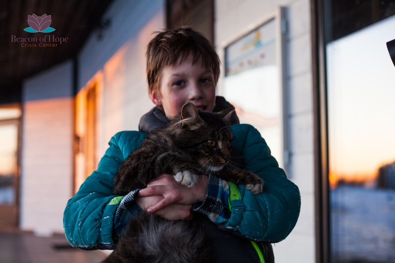 Child holding a cat