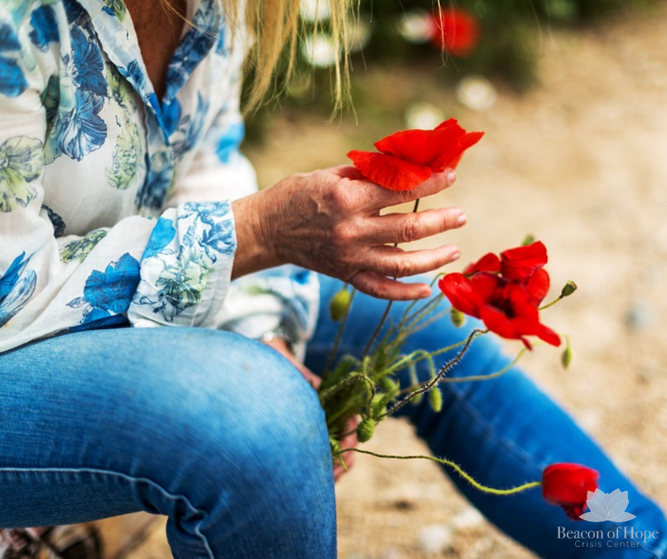 Person holding red flowers